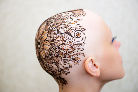 Drawing process of henna mehndi ornament on womans head