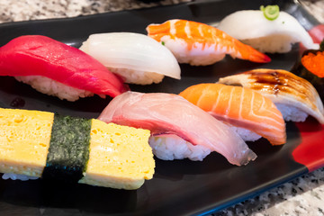 Selective focus of mix sushi sashimi on dish in the restaurant (Japanese food)