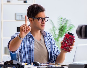 Vlogger recording computer repair on camera for vlog blog