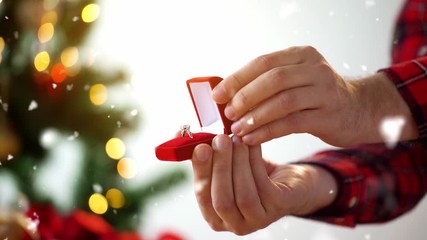 holidays, engagement and proposal concept - male hands opening gift box with diamond ring on christmas