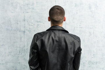 Young rocker man from behind, looking back.