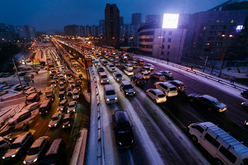 Car traffic jams due to snowfall in the evening.