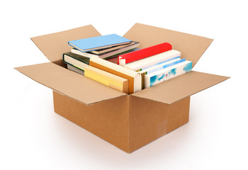 Moving house cardboard box filled with books, isolated on white background. Contains clipping path.