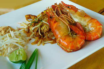 Pad Thai shrimps on a white plate - Thai food