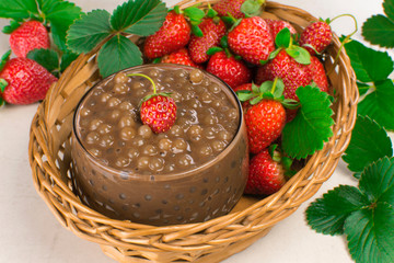 Brazilian dessert made of tapioca pearls called sagu in chocolate flavor in a basket with strawberries