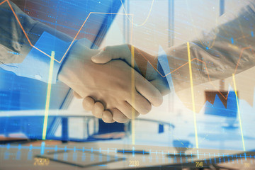 Multi exposure of financial graph on office background with two businessmen handshake. Concept of success in business