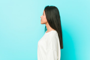 Young pretty hispanic woman gazing left, sideways pose.