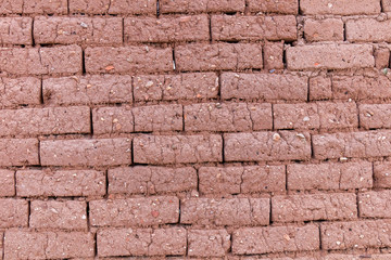 Brick wall from dry brown dirt stone typical for south America