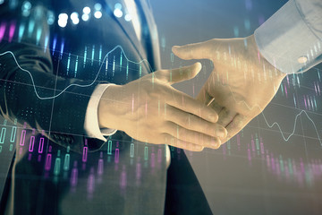 Multi exposure of forex graph on abstract background with two businessmen handshake. Concept of success on stock market