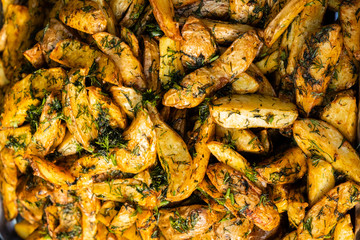 Delicious baked potatoes with rosemary closeup, street food