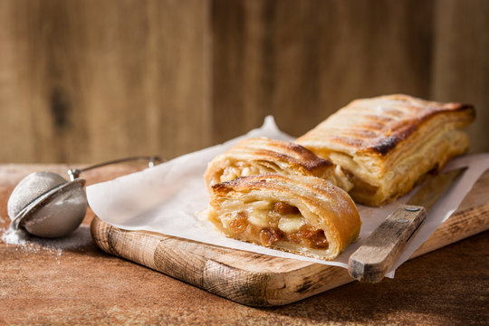 Traditional homemade apple strudel on brown background