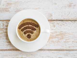 Wifi symbol drawn on cup on wooden background
