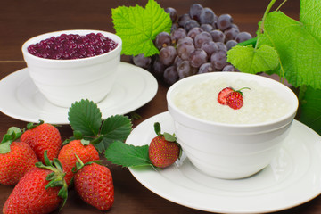 Brazilian dessert made of tapioca pearls called sagu in cream and red wine flavors with grapes and strawberries in wood background