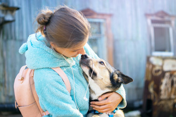 Beautiful woman playing with dog. Outdoor portrait. selective focus