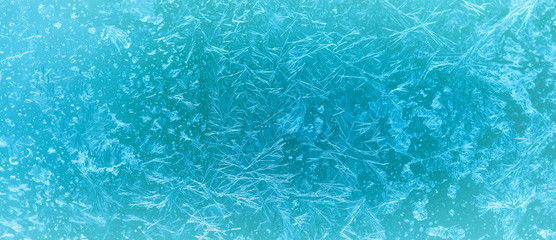 Ice flowers and frozen window macro view. Frost texture pattern. cold winter weather xmas background concept.