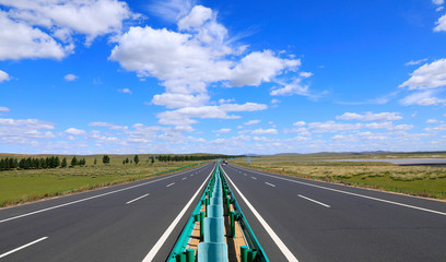 Fototapeta premium Beautiful highway, under the blue sky and white clouds