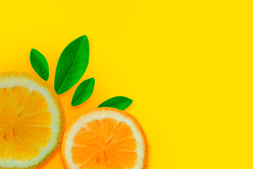 Lemon vitamin C. Fresh orange citrus fruit with leaves isolated yellow backgrounds. Flat lay copy space