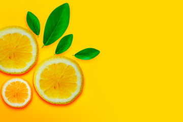 Lemon vitamin C. Fresh orange citrus fruit with leaves isolated yellow backgrounds. Flat lay copy space