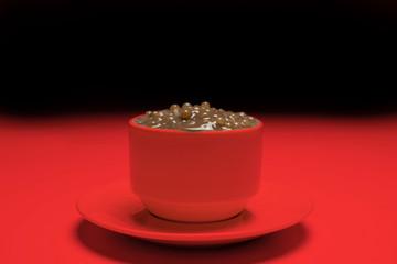 Brazilian dessert made of tapioca pearls called sagu in chocolate flavor in a red cup and background