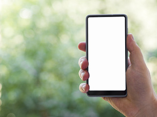 Hand holding phone mock-up with defocused background