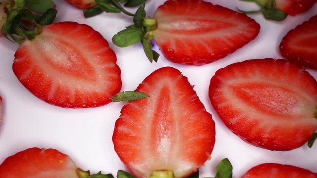 Strawberry Slices Half Strawberries footage video on slow motion rotating rolling plate
