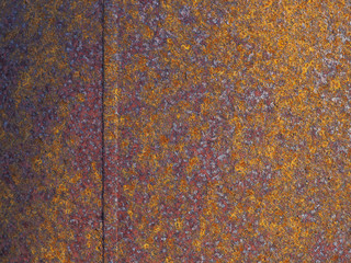 Rusty iron surface with a vertical seam. Picture for background. Close-up