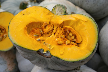 halved lumina pumpkin with grey skin and orange fruit flesh, decorative autumn vegetable for halloween and thanksgiving, selected focus