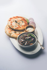Pindi Chole Kulche or roadside choley Kulcha popular in India and pakistan is a popular streetfood. It's a spicy Chickpea or chana curry served with Indian Flat Bread. selective focus