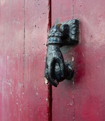 Old doorknob on red door