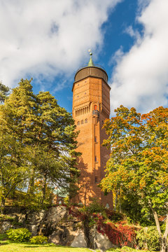 Gamla Vattentornet, Skolgatan 13, S&auml;ffle, Sweden, October 5, 2019: 45 meter high water tower of S&auml;ffle designed by architect Ivar Justus Tengbom surrounded with trees in autumn colors