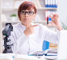 Female scientist researcher conducting an experiment in a labora