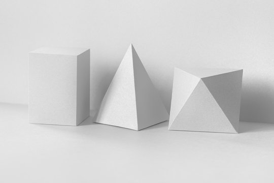 Geometrical figures still life composition on white. Beautiful three-dimensional pyramid rectangular cube objects. Platonic solids figures, simplicity concept photography