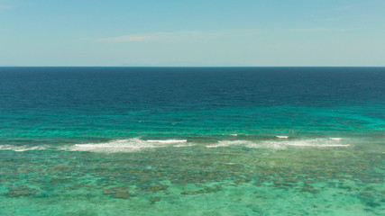 Blue background with transparent sea water copy space for text. Sea water surface in lagoon and coral reef. Top view transparent turquoise ocean water surface. background texture
