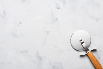 Pizza cutter with wooden handle on table top view