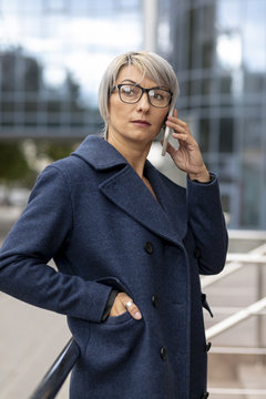 Woman On Balcony Talking Over Phone