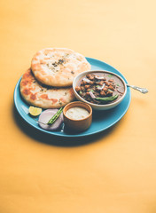 Pindi Chole Kulche or roadside choley Kulcha popular in India and pakistan is a popular streetfood. It's a spicy Chickpea or chana curry served with Indian Flat Bread. selective focus