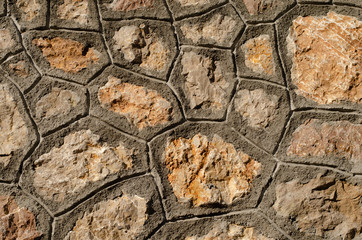 Building  wall  made from  natural river stone and cement . Country rustic  background