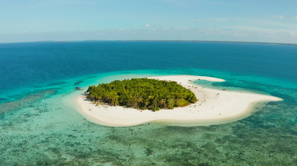 Tropical landscape: small island with beautiful beach, palm trees by turquoise water view from above. Patawan island with sandy beach. Summer and travel vacation concept.