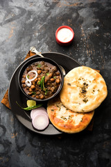 Pindi Chole Kulche or roadside choley Kulcha popular in India and pakistan is a popular streetfood. It's a spicy Chickpea or chana curry served with Indian Flat Bread. selective focus