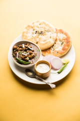Pindi Chole Kulche or roadside choley Kulcha popular in India and pakistan is a popular streetfood. It's a spicy Chickpea or chana curry served with Indian Flat Bread. selective focus
