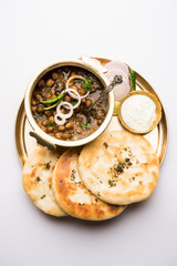 Pindi Chole Kulche or roadside choley Kulcha popular in India and pakistan is a popular streetfood. It's a spicy Chickpea or chana curry served with Indian Flat Bread. selective focus