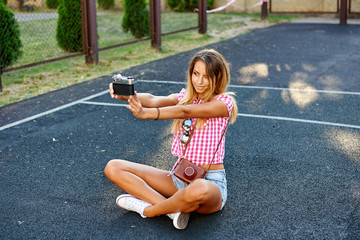 Portrait of a pretty girl taking a selfie outdoor