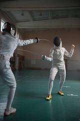 A portrait of a woman fencers while they are training