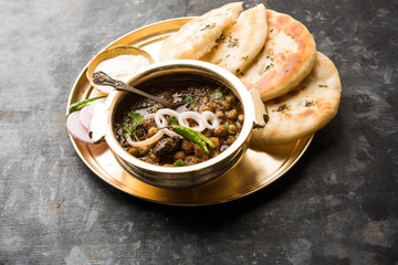Pindi Chole Kulche or roadside choley Kulcha popular in India and pakistan is a popular streetfood. It's a spicy Chickpea or chana curry served with Indian Flat Bread. selective focus