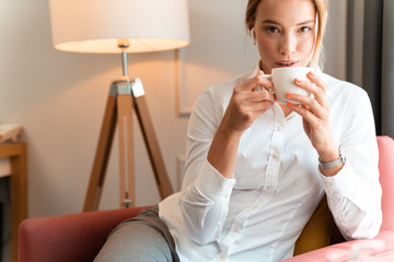 Business woman using wireless bluetooth earphones.