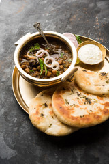 Pindi Chole Kulche or roadside choley Kulcha popular in India and pakistan is a popular streetfood. It's a spicy Chickpea or chana curry served with Indian Flat Bread. selective focus