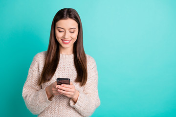 Portrait of positive interested lady using her cellphone red social media account news wear knitted...