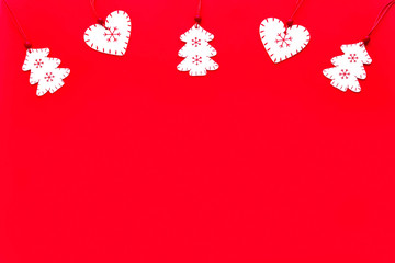 White wooden christmas decorations  heart and tree on red background. Merry Christmas and Happy New Year concept. Top view, flat lay, copy space.
