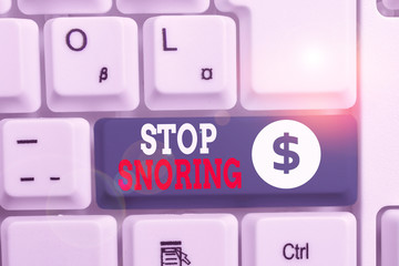Writing note showing Stop Snoring. Business concept for noisy breathing during sleep due to vibrating airway tissue White pc keyboard with note paper above the white background