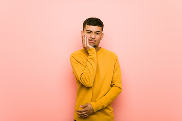 Fototapeta premium Young hispanic man who is bored, fatigued and need a relax day.